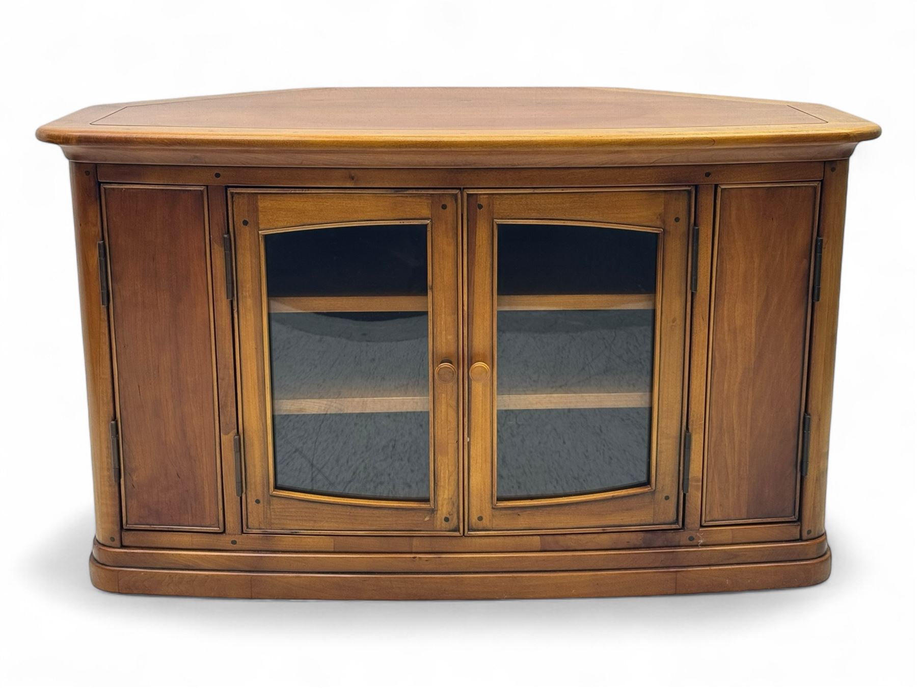 Contemporary cherry wood corner TV unit, canted top over central glazed double doors opening to shelves for media storage, flanked by side storage compartments, on a plinth base