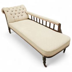 Late 19th century cream upholstered chaise longue, patterned pale damask fabric, padded arm with spindle back gallery raised on turned legs upon castors
