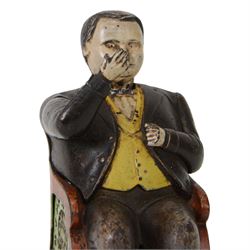 Late 19th century American cast iron Tammany mechanical money box, modelled as a suited gentleman with yellow waistcoat seated in a red and green chair, with two patent marks for Dec 23rd 1873 and June 8th 1875, H14cm