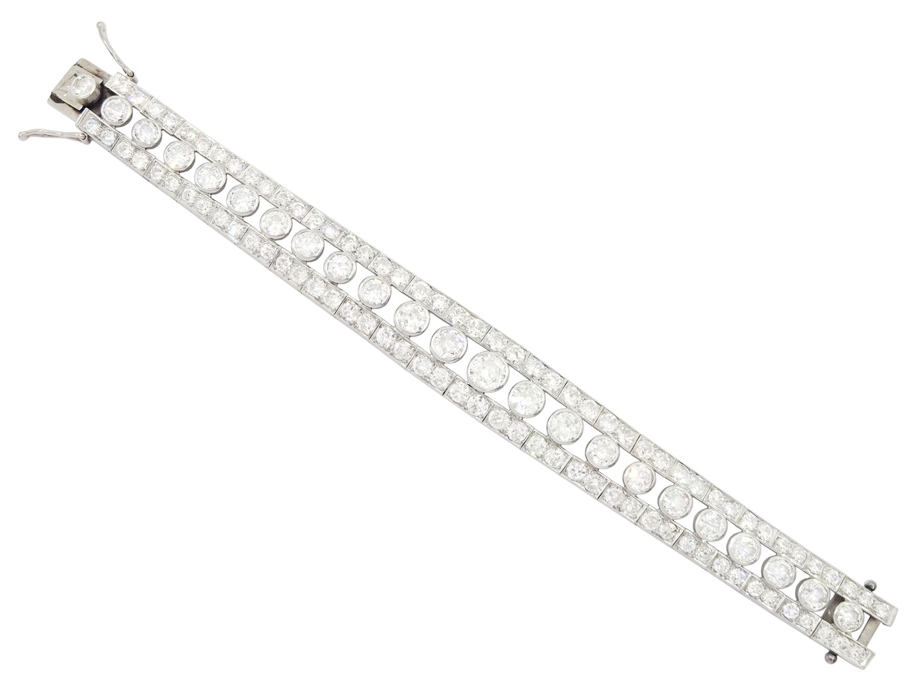 Continental Art Deco platinum old cut diamond openwork bracelet, circa 1920's, twenty-two bezel set graduating diamonds of approx 9.45 carat, the principal diamond approx 0.90, with a row milgrain set diamonds either side, the clasp set with a single diamond, the bracelet sides and clasp with engraved foliate decoration, total diamond weight approx 20.60 carat