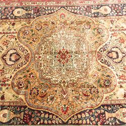 Azerbaijan rug, intricate central medallion in muted golds and greens surrounded by navy panels filled with boteh and floral designs, enclosed by a red main border featuring stylised boteh motifs, woven in the Caucasus region of Azerbaijan