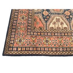 Persian design indigo ground carpet, the field decorated with extended lozenge panels with stylised floral designs, guarded border with repeating plant motifs and rinceaux 