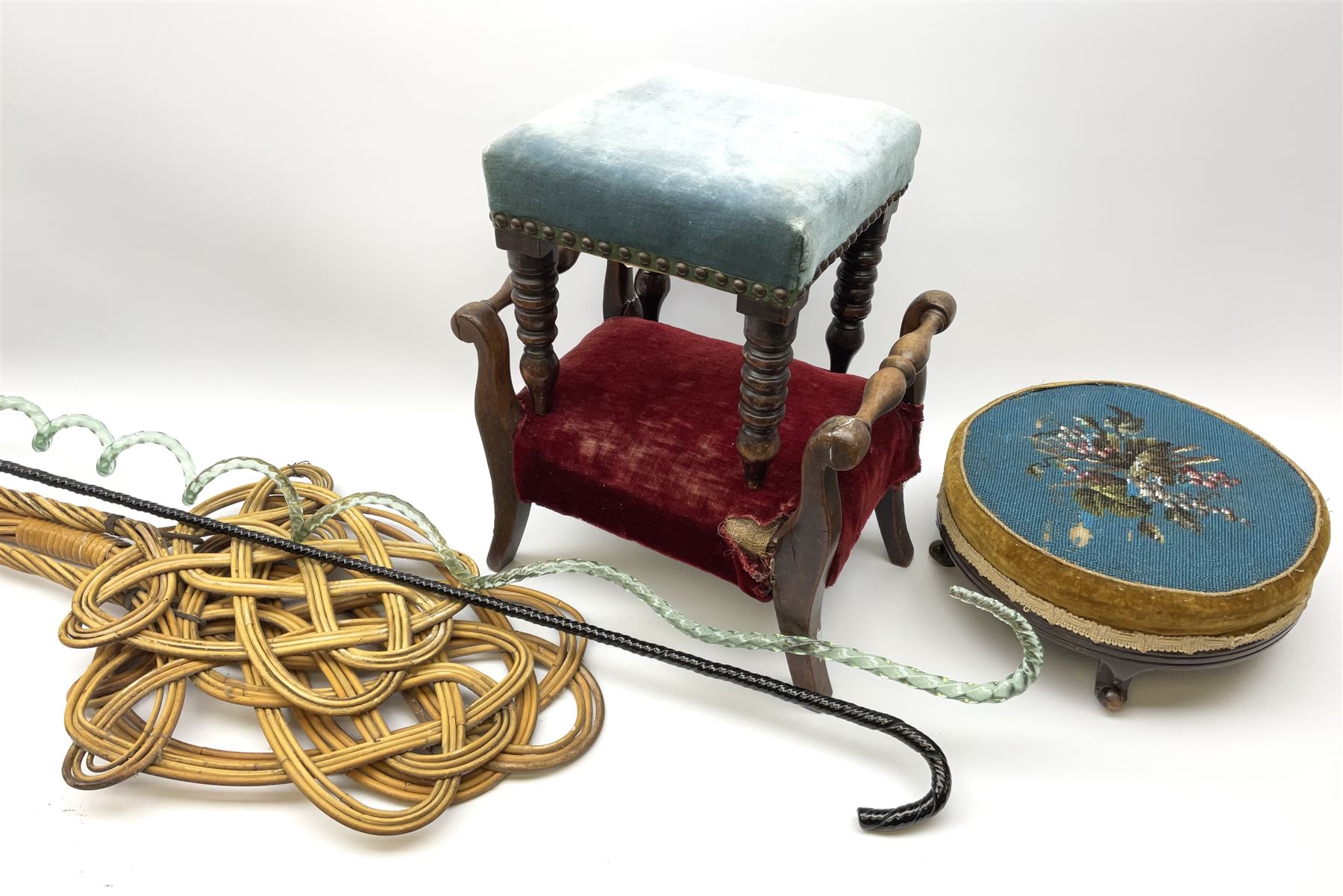 Victorian beadwork footstool with two other wooden upholstered footstools, one with turned bobbin legs, two Victorian glass frigger canes, one of twisted spiral form, and three carpet beaters