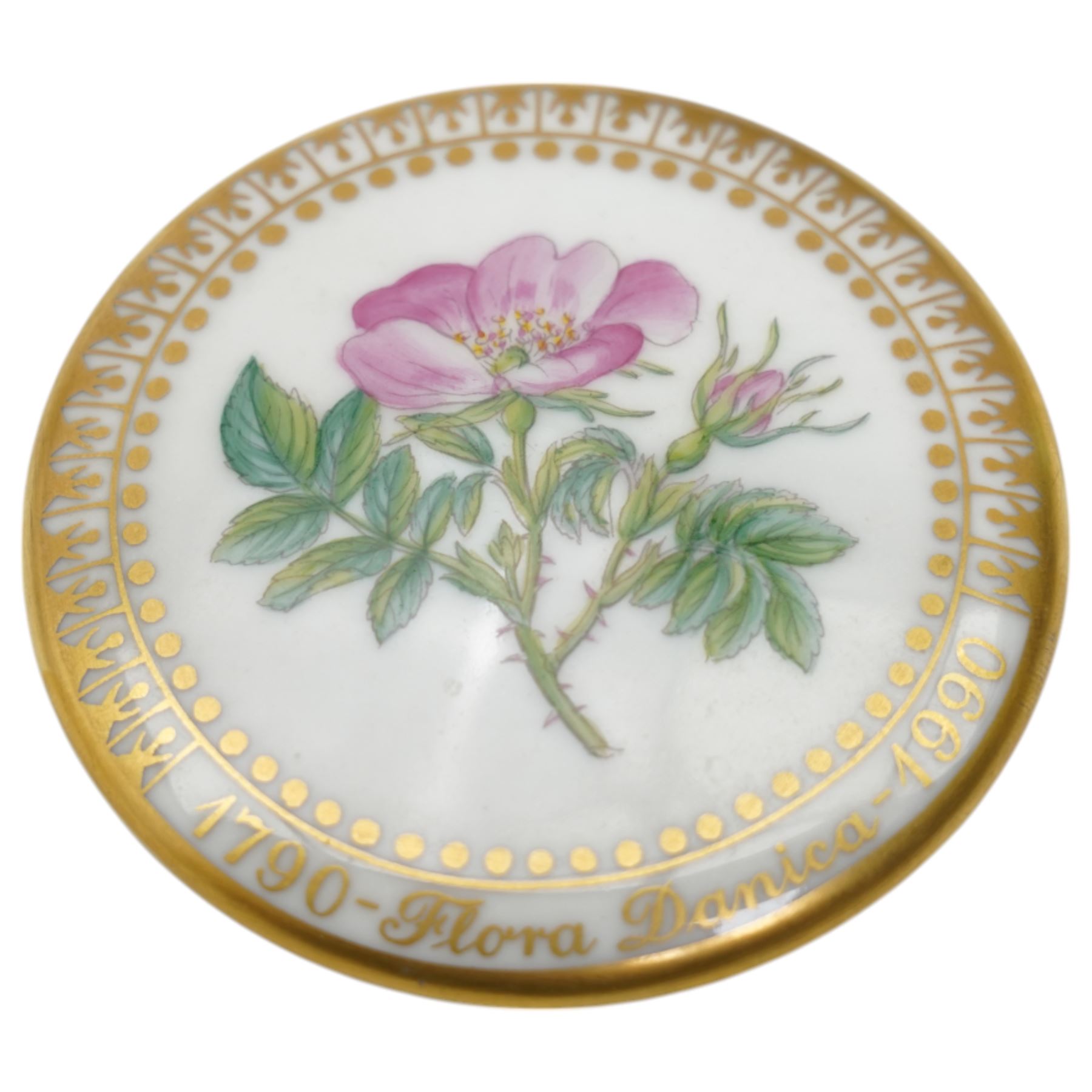 Royal Copenhagen Flora Danica wares, comprising covered mustard pot with naturalistically modelled vine handles and decorated with Cushion Pink (Cucubalius Acaulis) H8cm, milk jug decorated with Maiden Pink (Dianthus Deltoides) H7cm, covered dish decorated with Dwarf Milkwort (Polygala Amarum) W8cm, oval salt cellar decorated with Alpine Squill (Scilla Bifolia) W11cm, egg cup, pin dish and cased hand mirror, various Latin specimen inscriptions to base, all with printed and painted marks beneath (7)