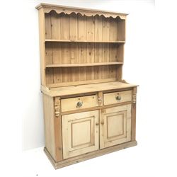 Solid pine dresser raised two tier plate rack, two drawers above two cupboards, platform base