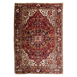 North West Persian Ahar hand-knotted carpet, madder red ground, with a large central shape...