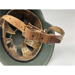 Fully restored German steel helmet, the camouflage painted exterior with two decals and replacement leather liner