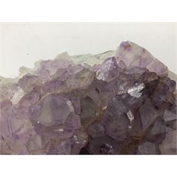 Amethyst crystal geode cluster, with well-defined crystals of various sizes, H10cm, L30cm