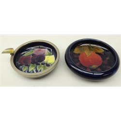  Moorcroft dish decorated in the pomegranate pattern on blue ground, D11cm, and Moorcroft dish decorated with plums on blue ground with a metal mount converted to an ashtray, D10cm  