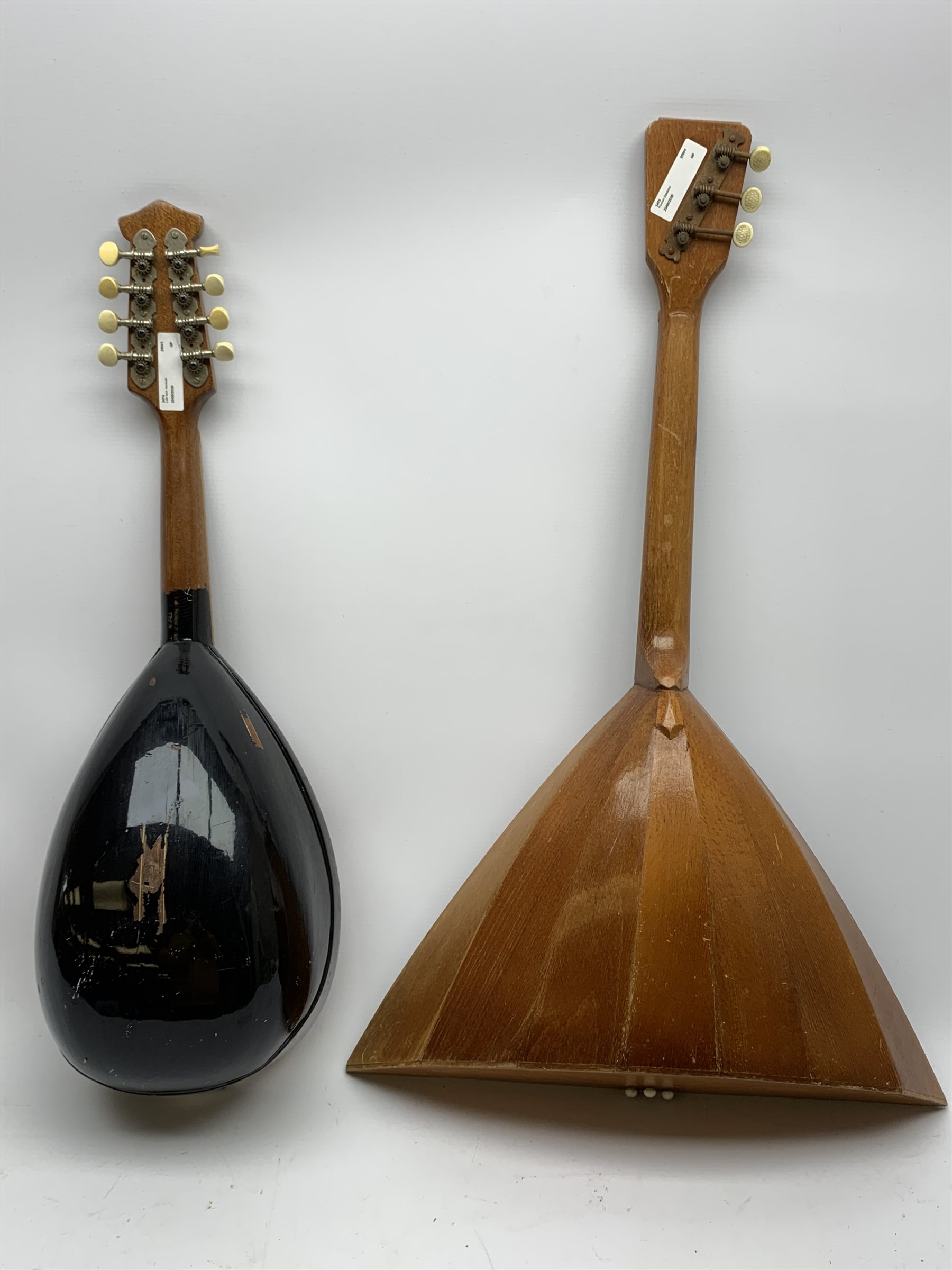 Italian lute back mandolin with black lacquered segmented rosewood back and spruce top L64cm; together with a Russian three-string balalaika of typical triangular form with faceted back and spruce top, bears label, L70cm (2)