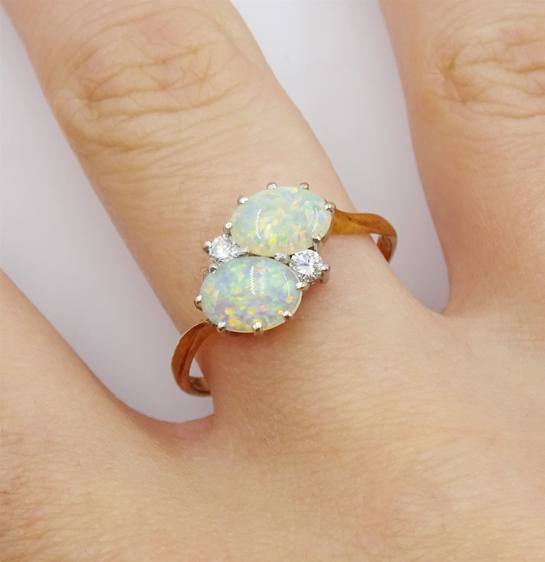 18ct gold two stone oval opal and two stone round brilliant cut diamond crossover ring, London 1981
