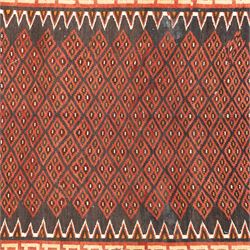 North west Persian Yamut Kilim, madder field with all-over lozenge lattice and serrated edges, with stepped end-panels and bold geometric borders in red, ivory and black