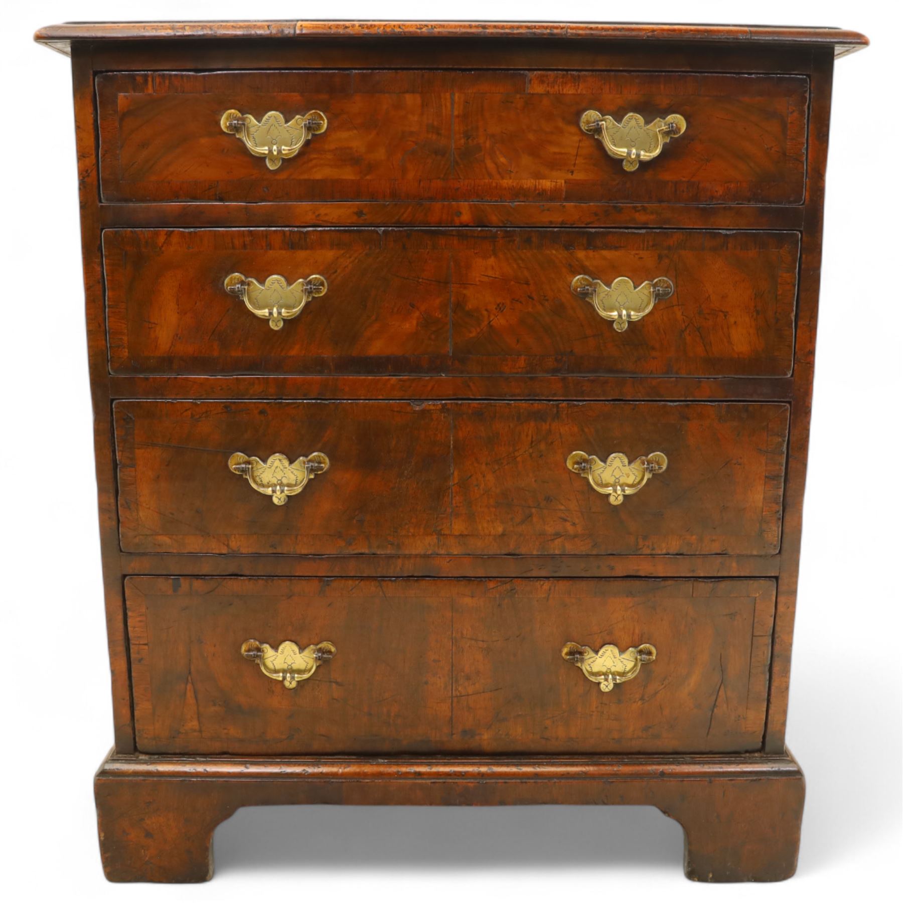 Small 19th century figured walnut chest of drawers, rectangular top with moulded edge over four graduating drawers with brass batwing handles, raised on bracket feet
