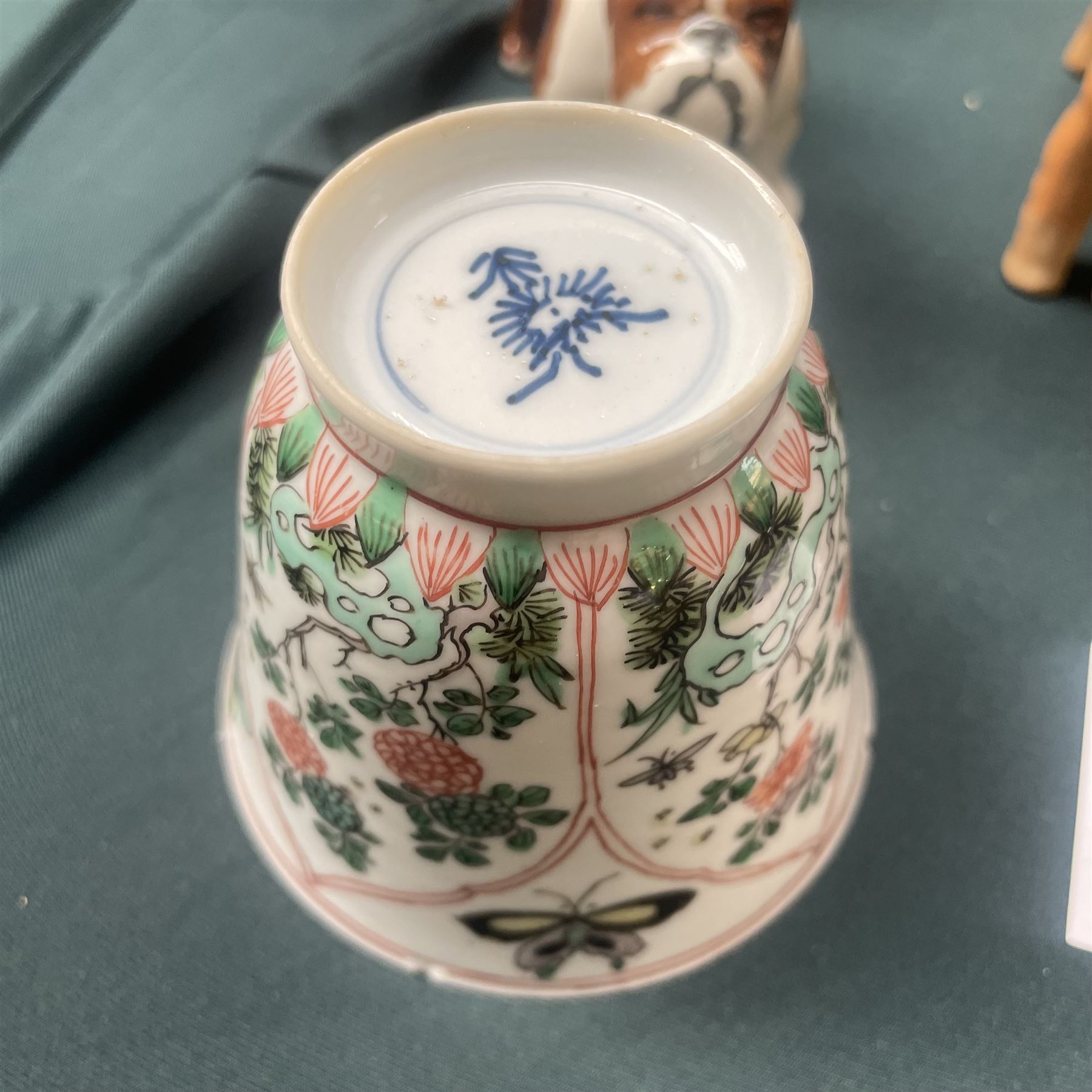 Three Chinese famille verte examples, approximately Yongzheng period, to include two teabowls and two saucers, each decorated with flowers and butterflies, two with sacred fungus mark within double rings, the teabowl with lotus mark, the other indistinct - possibly a Wan mark within lozenge (4)