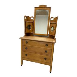 Early 20th century satin walnut dressing chest, fitted with raised mirror and two small cupboards with circular mirrors, rectangular top over three drawers, square supports with brass castors