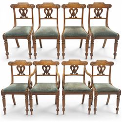 Set of eight (6+2) Regency period mahogany dining chairs, the ornately carved cresting rail of gadrooned and foliate design, over a pierced swan-neck splat with scrolling foliate carving, the carvers with scrolled arm terminals, over teal-upholstered drop-in seats, raised on Gillows-design reeded and tapering front supports, retailed by David Hick Interiors, Jersey