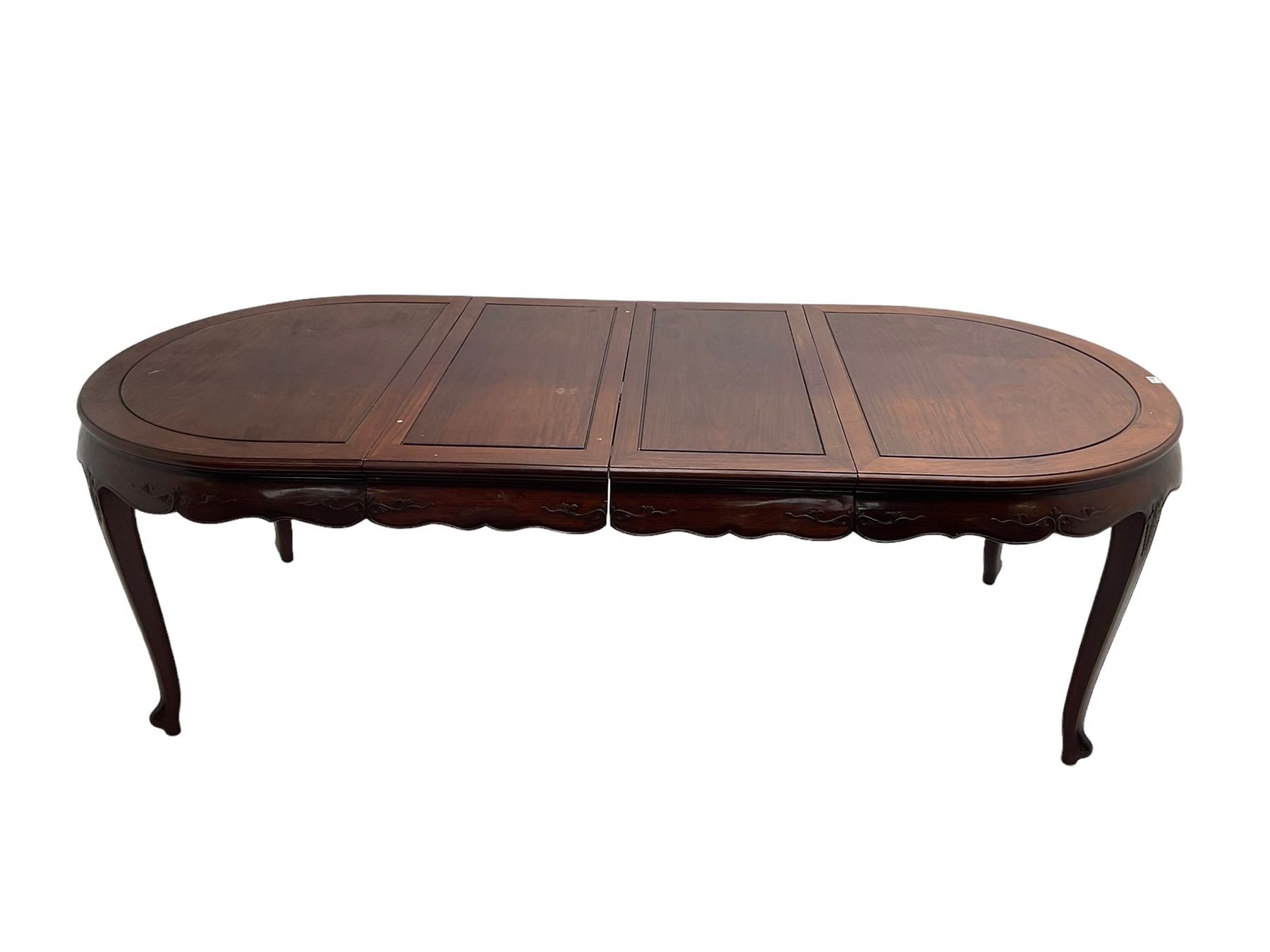 Mid to late 20th century Chinese hardwood extending dining table, two additional leaves, shaped apron carved with foliate scrolls, leaf carved cabriole supports (W246cm, H78cm, D117cm), and set six (4+2) dining chairs with shaped cresting rails over carved splats