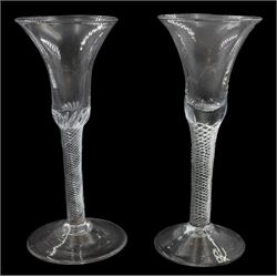 Two mid 18th century drinking glasses, each with bell shaped bowl upon a single series multi-ply spiral air twist stem and conical foot, each approximately H17cm