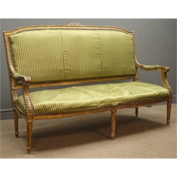  19th century gilt framed three seat sofa, floral carved cresting rail, scrolled arm rest, upholstered back seat and arms, on turned reeded supports  