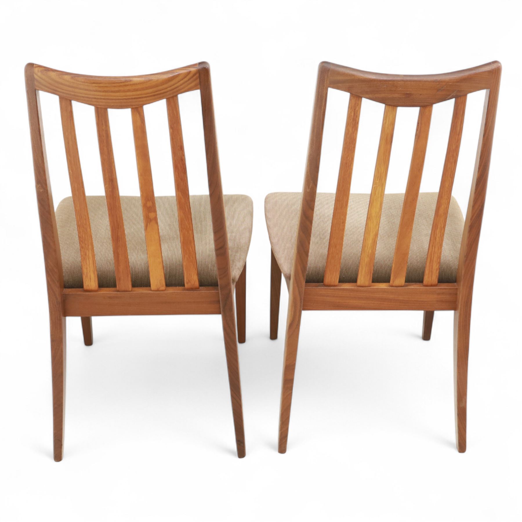 G Plan - mid-20th century teak extending dining table, oval top with integrated extension leaf, raised on tapering legs, together with a set of six slat back dining chairs including two carvers, upholstered in dark green velour (Extends to 210cm)