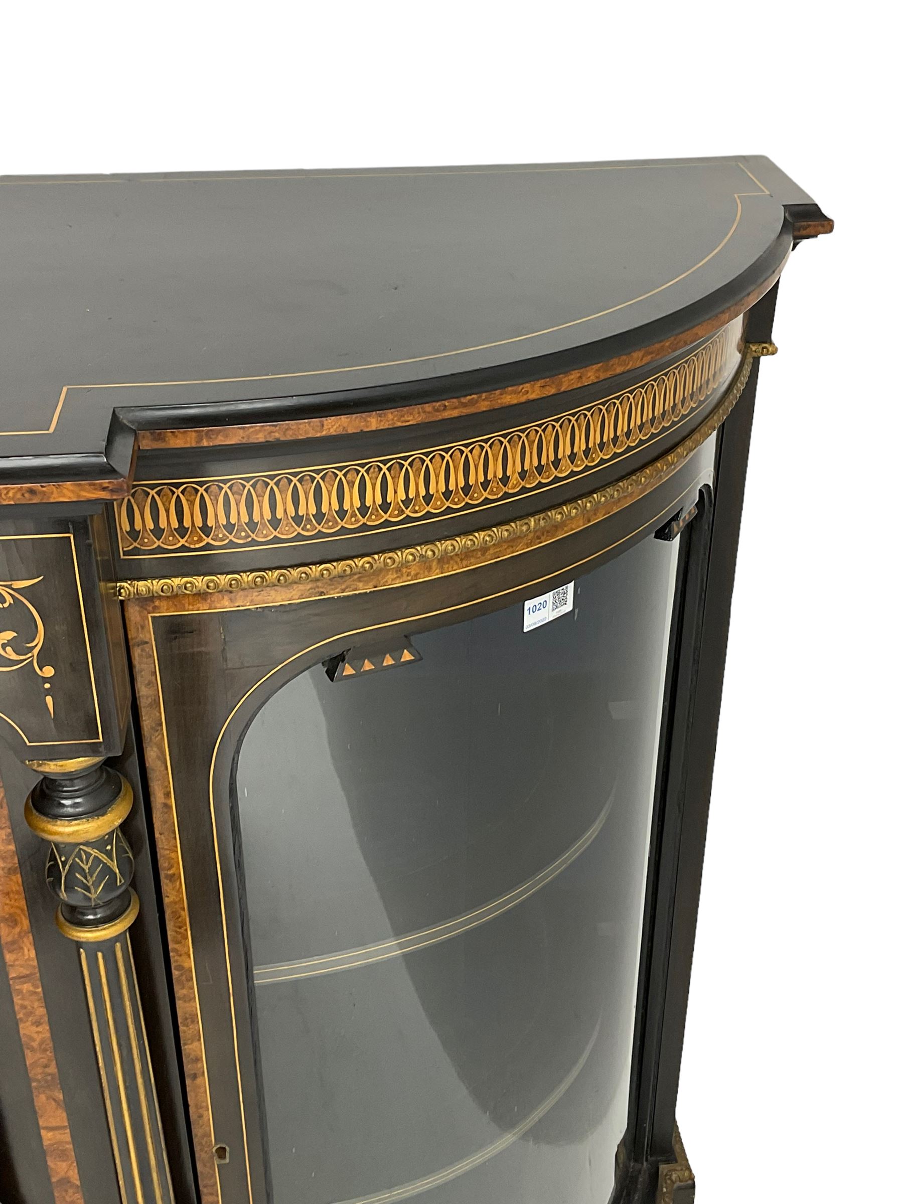 Victorian ebonised and inlaid credenza, break-front with curved ends, the front fitted with two curved glazed doors and central panelled door, inlaid with scrolling foliate and star motifs, quadruple turned and fluted pilasters to front, gilt egg and dart moulded edge on plinth base with figured walnut band, on turned feet