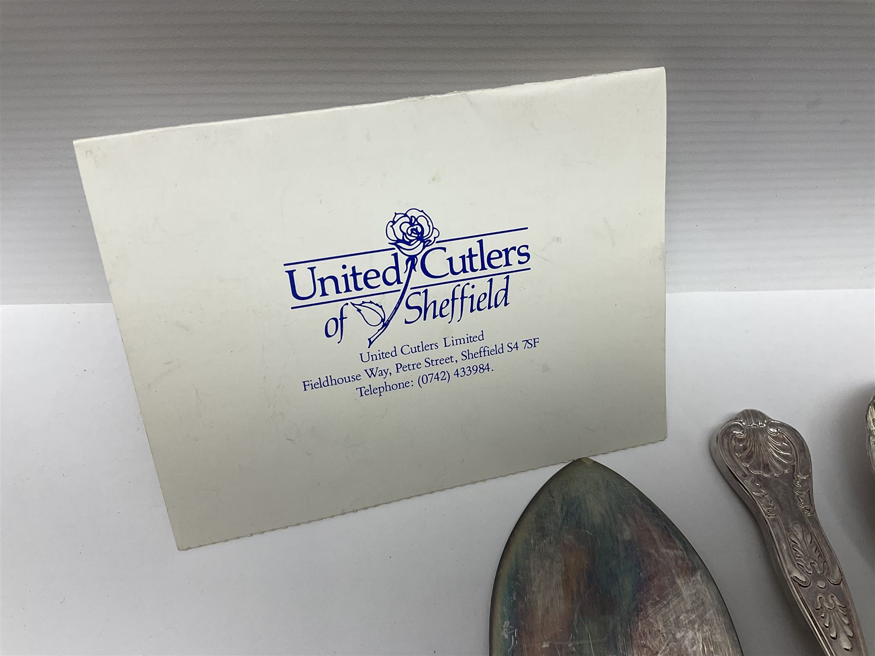 Silver Kings pattern knife, hallmarked Walker & Hall, together with a quantity of silver plated Kings pattern cutlery, including items by Osbourne's and United Cutlers, comprising table knives, table forks, table spoons, serving forks, ladle, berry spoons, teaspoons, dessert forks, cake slice, etc