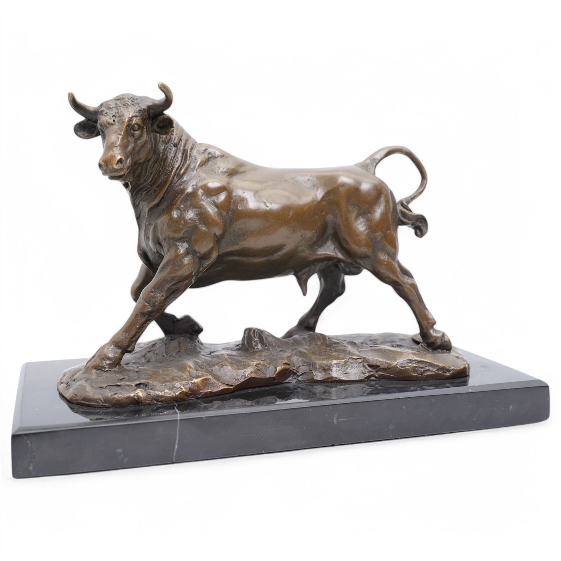 Bronze figure, modelled as a prancing bull, upon a rectangular marble base, bearing foundry stamp, overall H14cm L21cm

