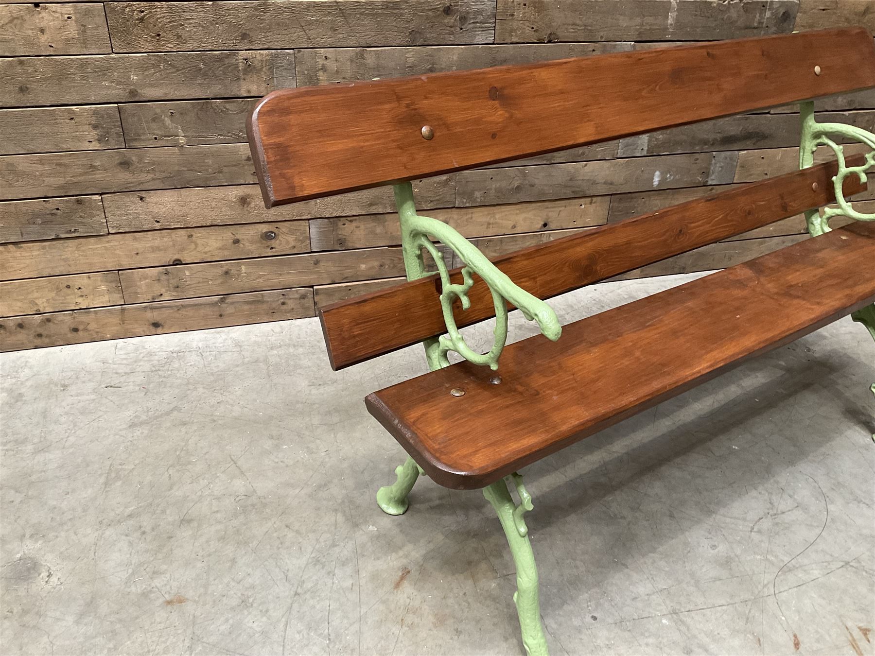 Cast iron and wood slate bench painted in green
