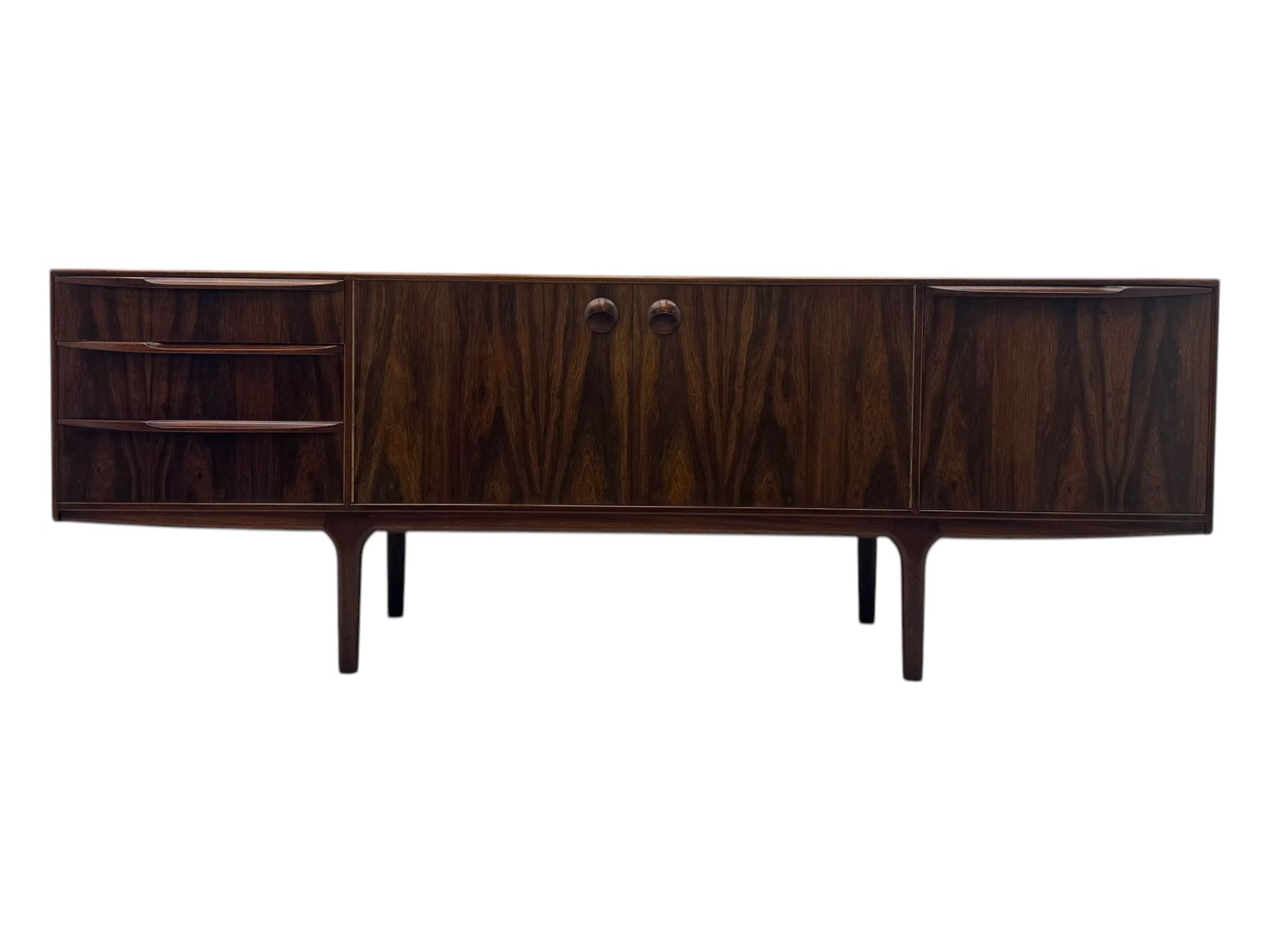 Tom Robertson for McIntosh of Kirkcaldy - mid-20th century 'Dunfermline' sideboard, the central twin cupboard doors flanked by bank of three drawers to one side and a fall front drinks cabinet to the other, raised on tapered supports