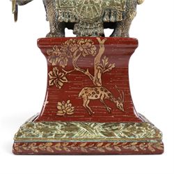 Wong Lee ceramic and brass obelisks, decorated with deer, trees and butterflies mounted on a brass elephant with brass to the base and top, H64cm