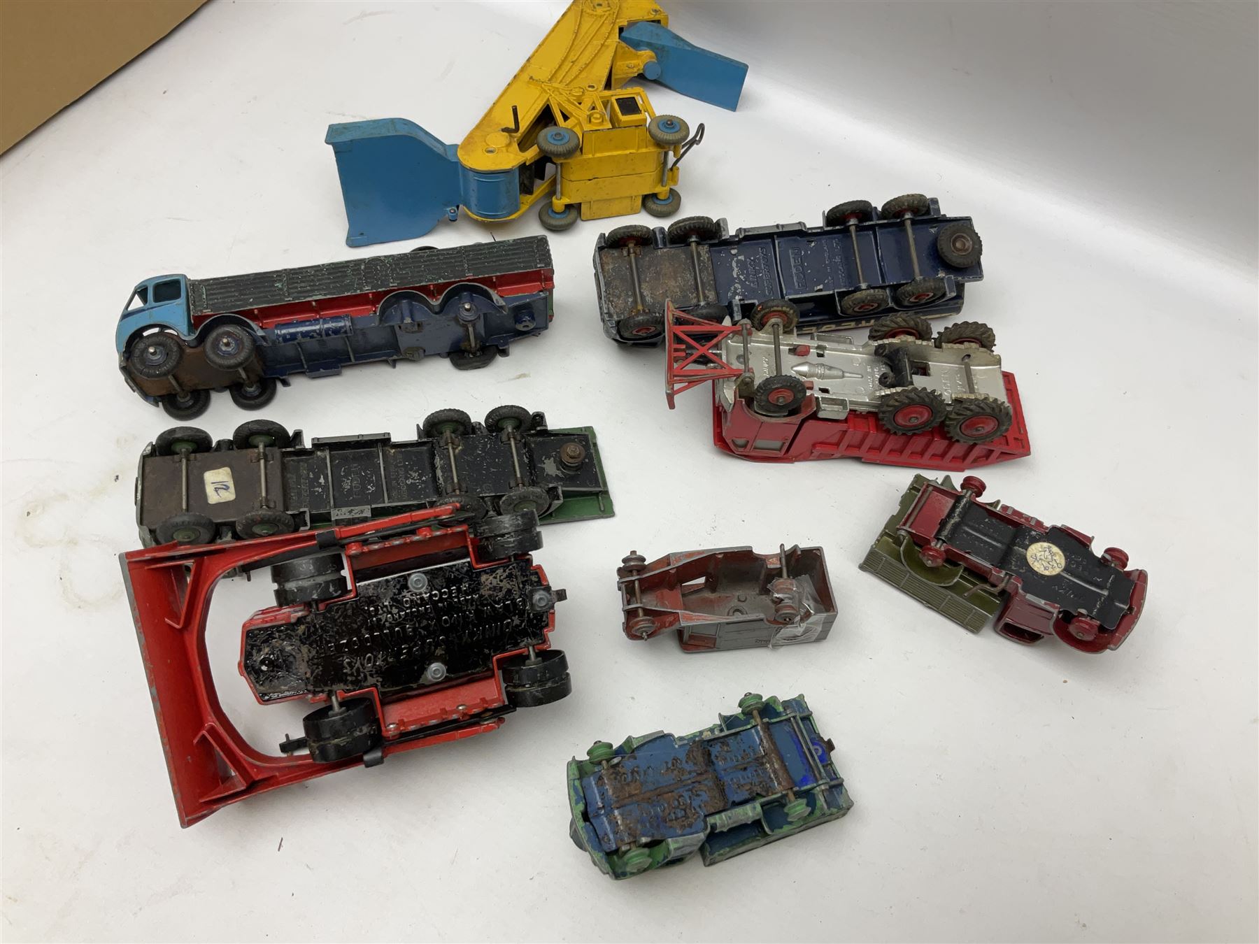 Dinky - twenty-six unboxed and playworn die-cast models including Foden Regent Tanker, two Foden lorries, Pressure Refueller No.642, Snow Plough, Elevator Loader, Foden Dump Truck, Blaw Knox Bulldozer and other commercial vehicles