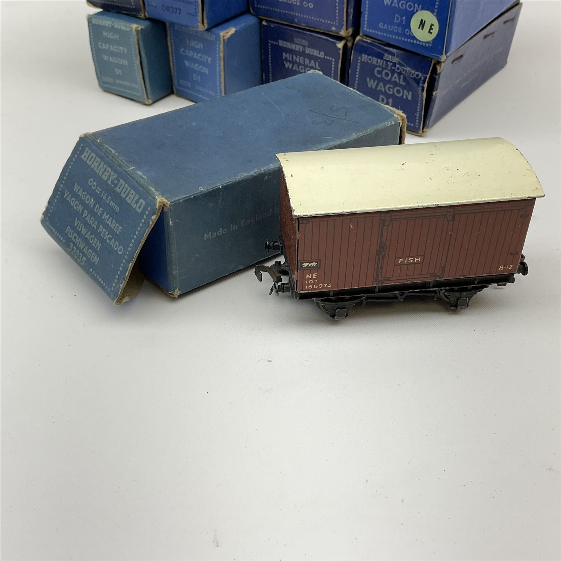 Hornby Dublo - thirteen D1/D2 wagons comprising Oil Tank Wagon 'Royal Daylight'; Coal Wagon; Fish Van; Mineral Wagon; two High Capacity Wagons; two Bogie Bolster Wagons; two Goods Brake Vans (one LMS and one BR/ER); two Open Wagons (one NE); and Cattle Truck; all in medium or dark blue boxes (13)