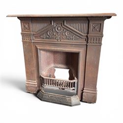 Late Victorian cast ion bedroom fireplace, decorated with floral poppy motifs and flluting
