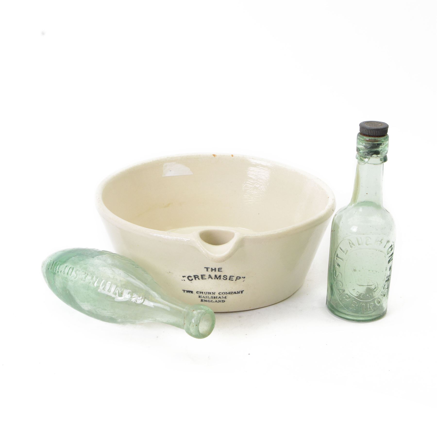 Cream separating bowl 'The Creamsep' and two glass bottles, one impressed 'T Laughton Scarborough', the other 'Genuine Superior Aerated Waters J Bordass Driffield', bowl D27.5cm