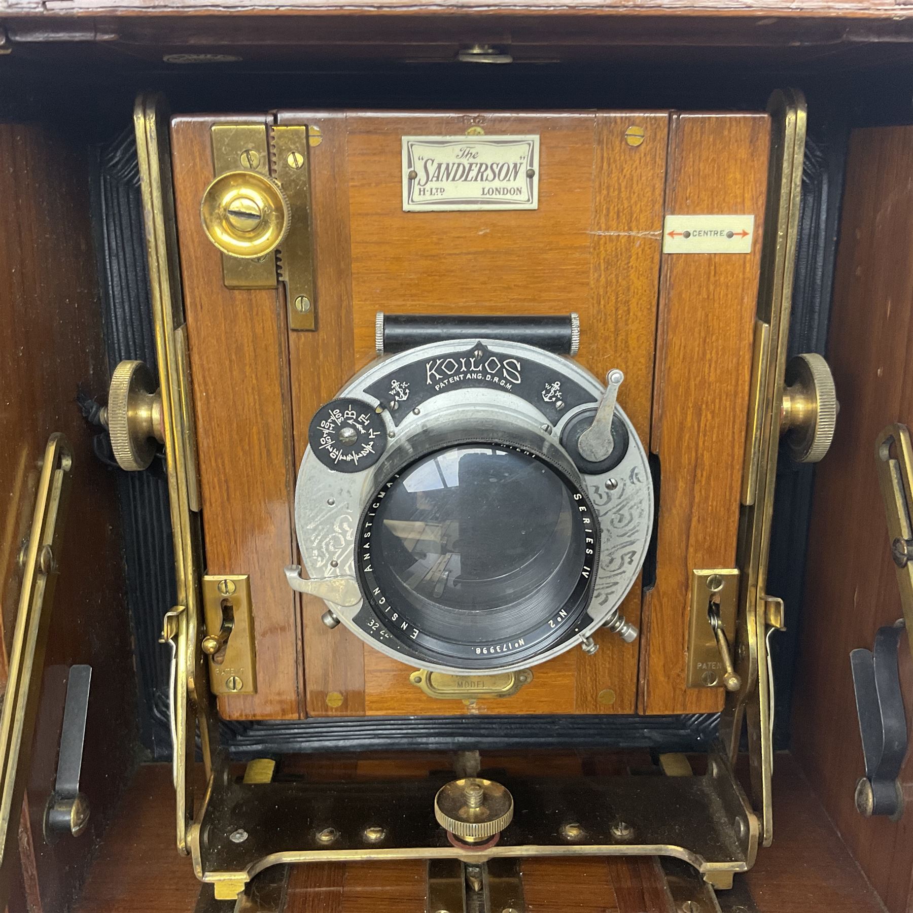 Sanderson Koilos folding plate camera in mahogany and lacquered brass, with 'Ensign Anastigmat Series IV No 2' lens, serial no 173998, with original leather case