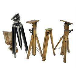 Three wooden adjustable tripods for plate cameras, together with a Linhof of Munchen metal tripod in a canvas case 