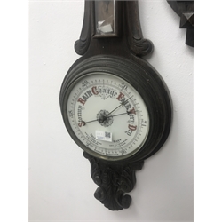 Early 20th century oak cased aneroid barometer with thermometer and another early 20th century oak cased barometer with carved detail
