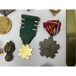 Collection of approximately sixty worldwide medals, metal badges, belt buckles, cloth badges, trench art, brass button stick etc