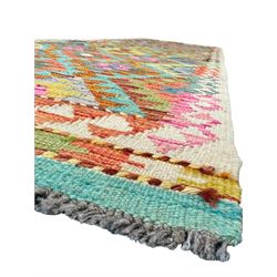 Tibetan-design handwoven rug, deep red field with three central medallions in yellow and blue, traditional yellow key border, white fringes on both ends