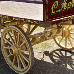 Advertising Trade Dray Wagon for C. Herring & Son, Hartlepool, Dated 1895 and Renovated 1975

An exceptionally decorative late Victorian horse drawn advertising trade dray, built by J. Herring of Hartlepool in 1895 and later renovated by C. Herring in 1975, as recorded by the painted inscription beneath the body. Finished in a striking cream and maroon livery with extensive hand painted signwriting, the wagon carries the name C. Herring & Son, Iron & Steel Processors, Hartlepool along its sides and rear panels. The wagon is fitted with a flat timber loading bed, twin shafts for a single horse, elegant spoked wooden wheels, iron bound tyres, rear headboard and traditional undercarriage with leaf spring suspension. Richly detailed scrollwork and lining throughout make this a particularly attractive example, suitable for collection, display, museum, promotional or coaching purposes.

Features

• Built by J. Herring, Hartlepool, 1895
• Renovated by C. Herring in 1975
• Original style hand painted advertising signwriting
• Flat timber loading platform
• Raised rear headboard with decorative pierced gallery
• Twin shafts for a single horse
• Wooden spoked wheels with iron tyres
• Traditional leaf spring suspension
• Extensive decorative lining and scrollwork throughout
• Attractive cream and maroon colour scheme
• Suitable for private collection, museum or display use

Dimensions:
Overall length: 560 cm
Body length: 300 cm
Width: 158 cm
Height: 150 cm

Wheel Diameters:
Front wheels: 76 cm
Rear wheels: 86 cm