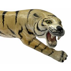 Large Lomonosov model of a tiger, L29cm, with printed mark beneath, together with another ceramic figure of a tiger, unmarked, L37cm. 