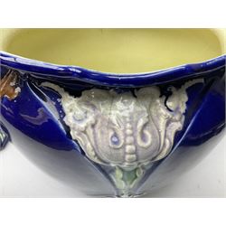 Early 20th century Majolica jardiniere and stand, with floral and foliate decoration upon a deep blue ground, H90cm