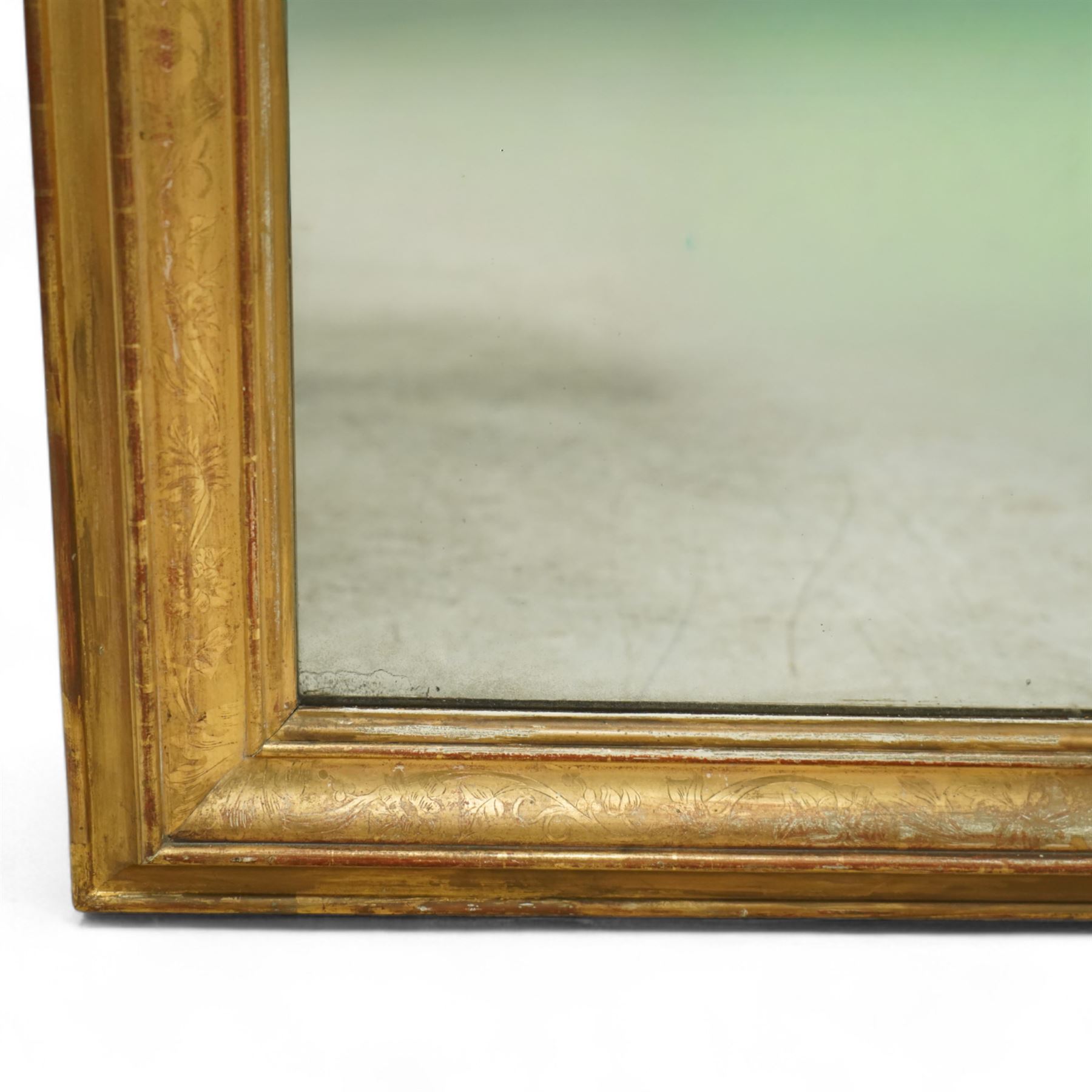 Louis XVI style gilt overmantel mirror, arched rectangular form with moulded frame, surmounted by a pediment carved with ribbon-tied grapevine and leaf decoration, enclosing a plain mirror plate, circa 1900