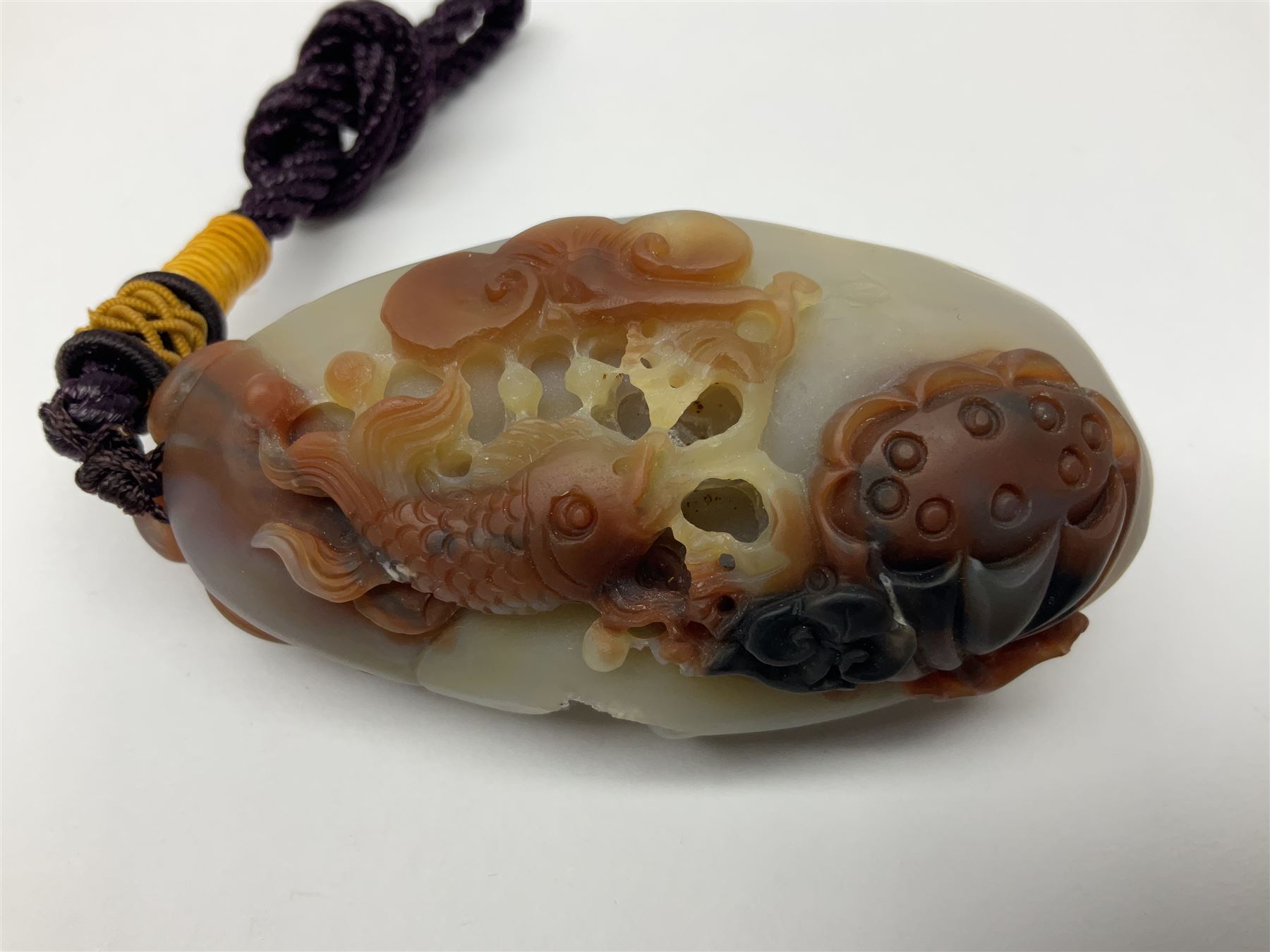 Chinese hardstone carving of a fish amongst coral, with platted rope handle, together with other hardstone and soft stone carvings  
