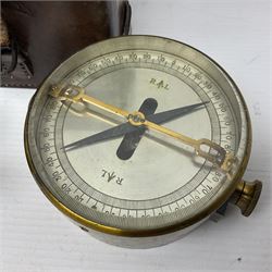 WWII British marching compass, the black lacquered brass case inscribed T.G.Co.Ltd. No.B100228 (broad arrow) 1941 Mk.III; and a ship's brass cased clinometer, the silvered dial marked R(arrow)L, D9cm; in leather carrying case (2)
