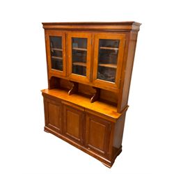 Multi-York -  Loire cherry wood dresser, shaped cornice over three glazed doors enclosing six shelves, the lower section fitted with three shallow drawers with shaped fronts over three cupboards with panelled doors, raised on plinth base with bracket feet