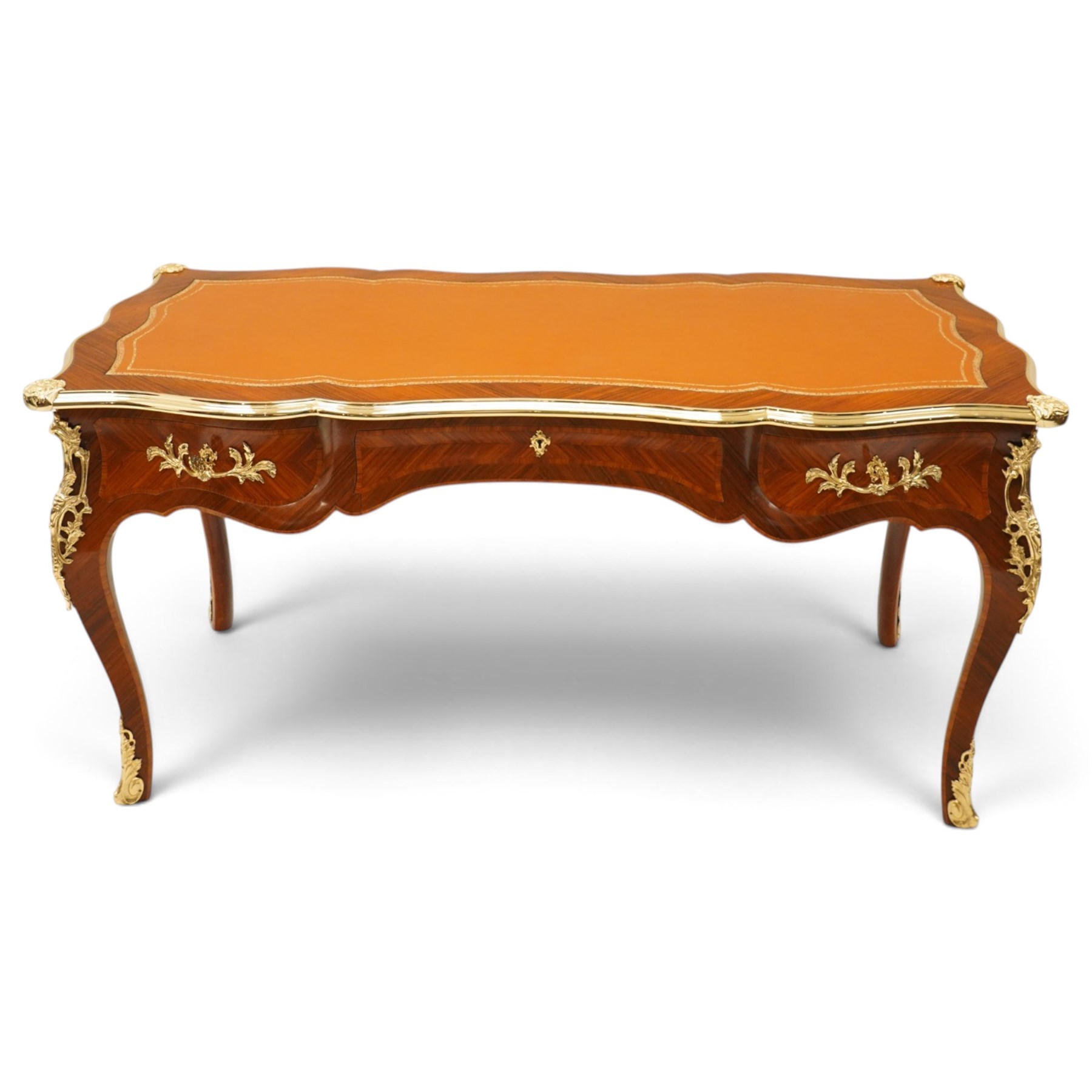 Baggio Anciens Meubles - Italian Louis XV style kingwood and gilt metal mounted bureau plat or writing desk, the shaped rectangular top with inset leather writing surface with gilt metal edge, above three shaped frieze drawers with gilt metal handles, raised on cabriole supports with gilt cartouche mounts to the knees and scroll feet