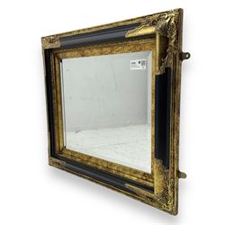 Victorian design ebonised and gilt wall mirror, the moulded rectangular frame decorated with foliate cartouches, bevelled mirror plate 