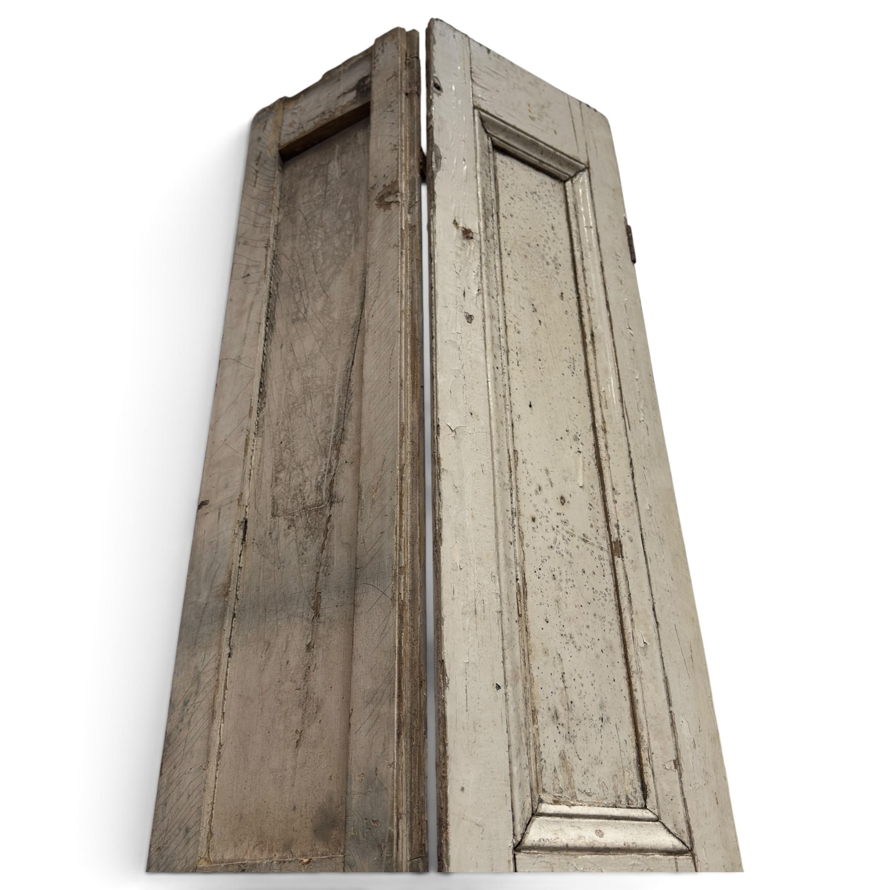 Set of three French 19th century painted pine folding window shutters of tall form, each comprising two hinged leaves with three graduated raised and fielded panels, in antique cream-painted finish