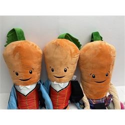 Three large ALDI Kevin carrots and giant unicorn stuffed toy together with quantity of smaller carrots